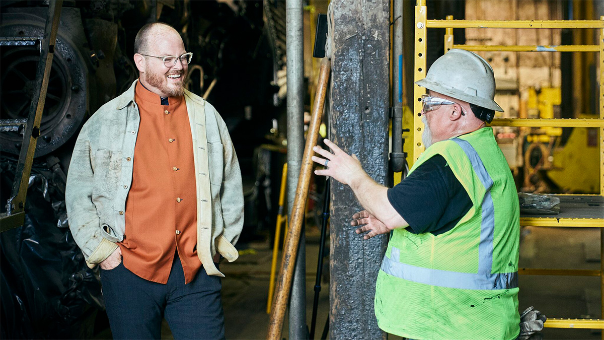 Futurist and AI keynote speaker Jonathan Brill in discussion with a man wearing a hard hat and safety vest